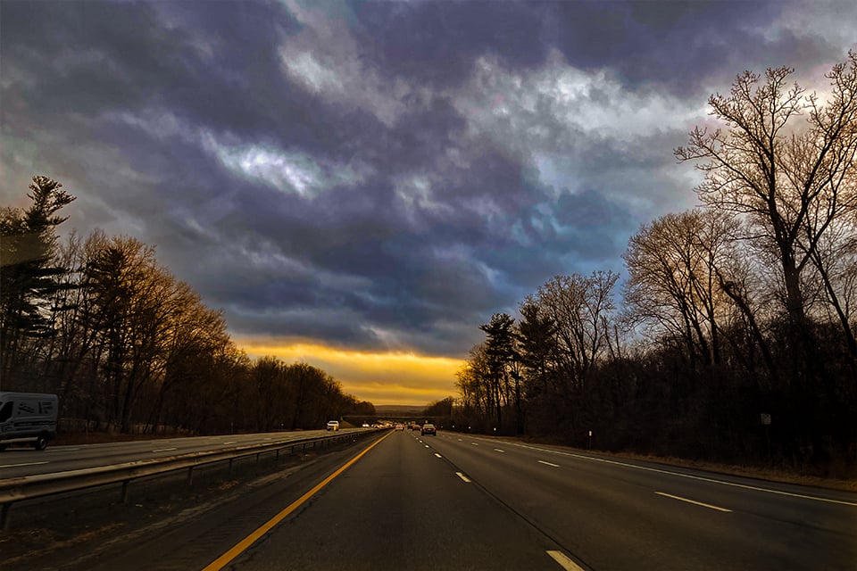 The sun rises over the open road.