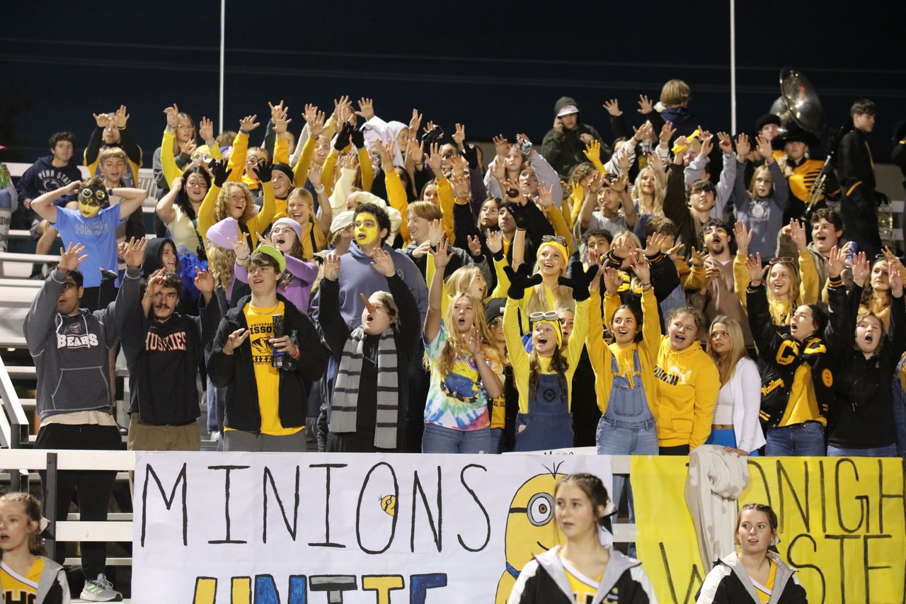 Student section cheering at a home football game