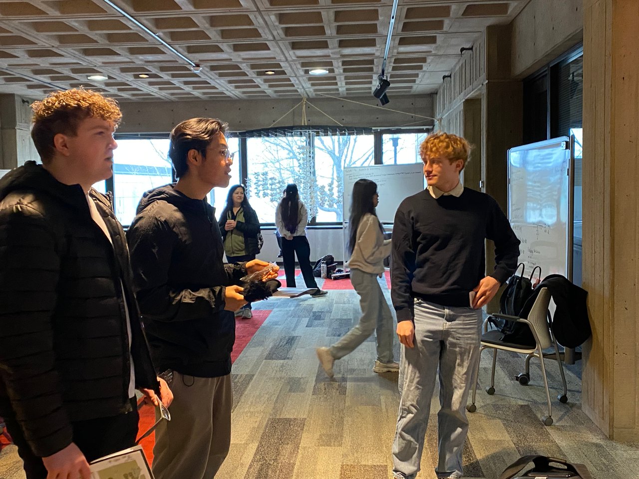 RPI students studying together at the Success Center, wearing sunglasses and holding cookies