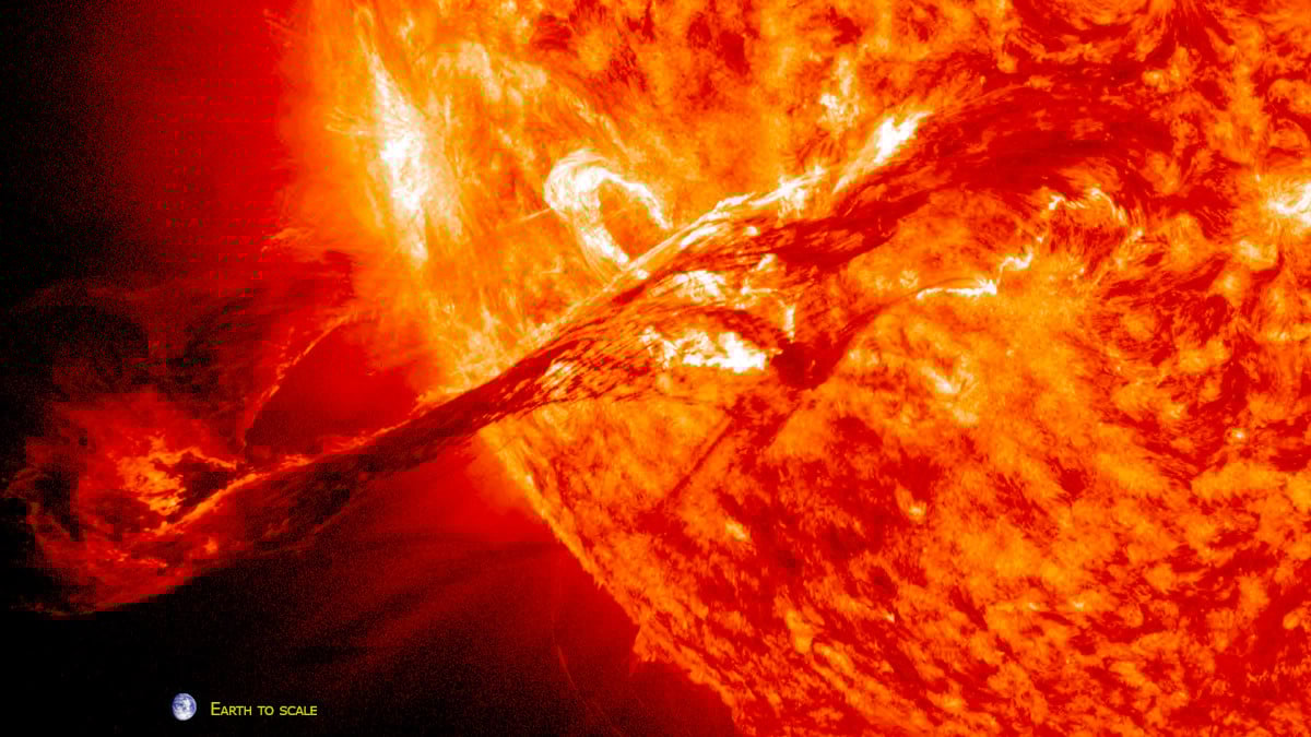 A Coronal Mass Ejection, or CME, on the sun flings a ball of plasma many times the size of the earth from the surface at more than 900 miles per second. An image of the earth added to the image just below the CME provides scale. NASA image.
