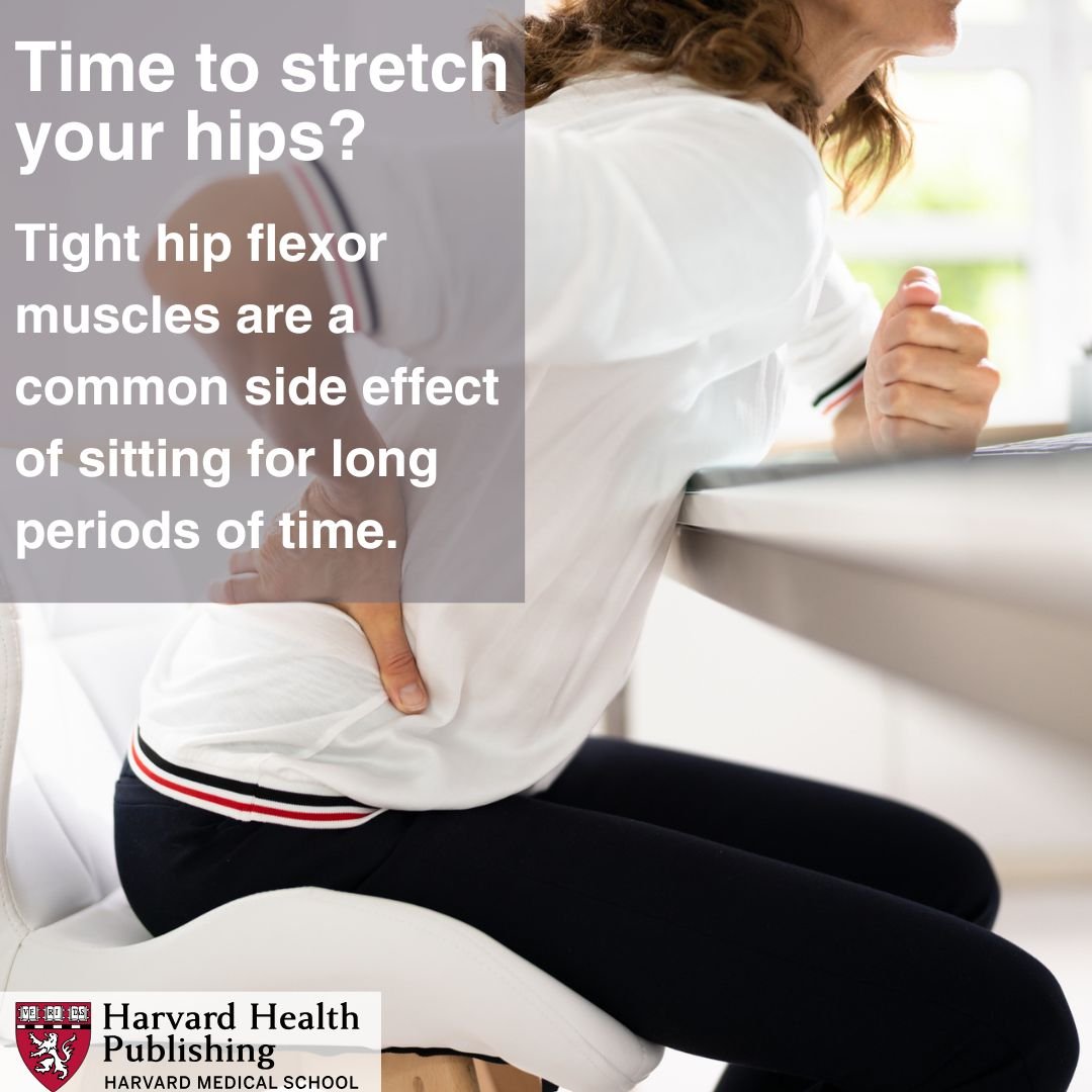 woman seated on a chair at desk, grabbing her hips in pain