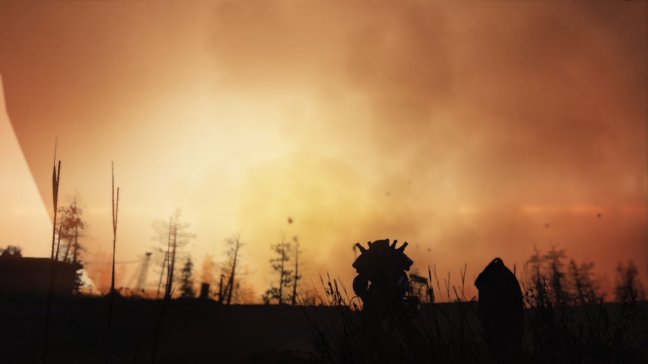 suit of power armor silhouetted against a burning orange sky moments after nuclear detonation