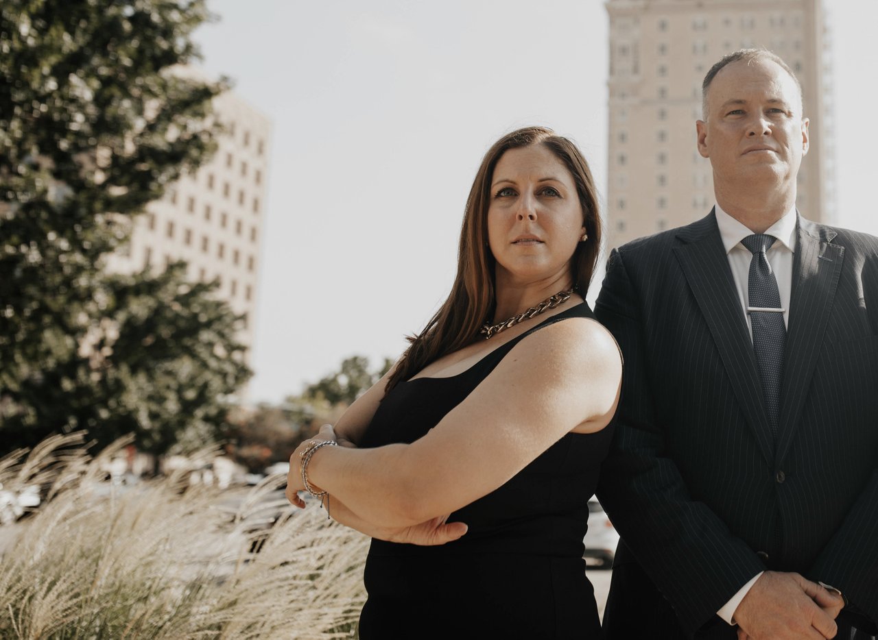 Two attorneys standing in front of a building.