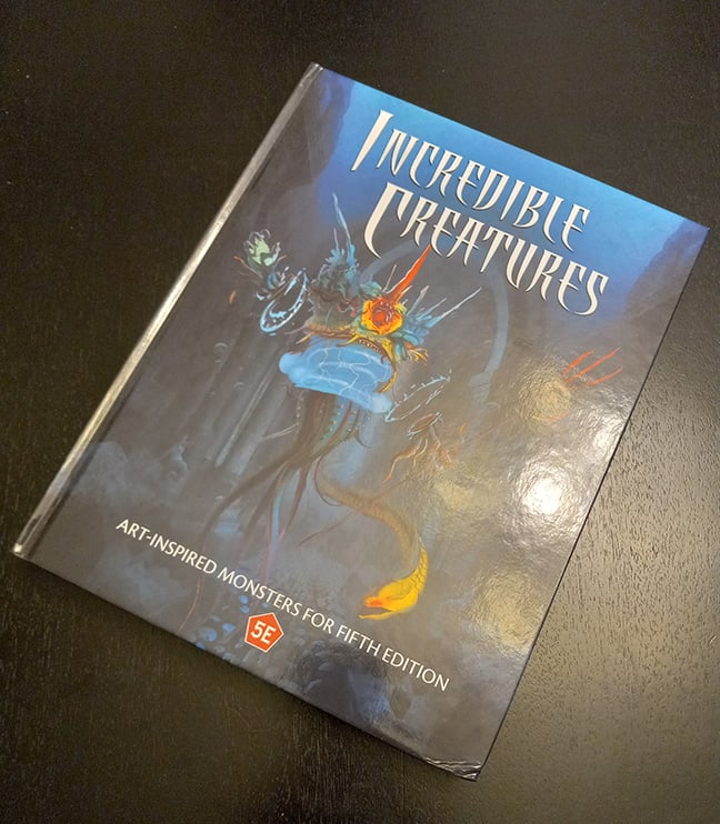A photograph of the cover of the print version of Incredible Creatures, the corner is mashed because it gets used.