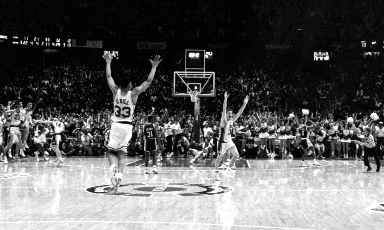 Christian Laettner and Grant Hill celebrating "the shot" on the court at the 1992 NCAA men’s basketball tournament East Regional Final