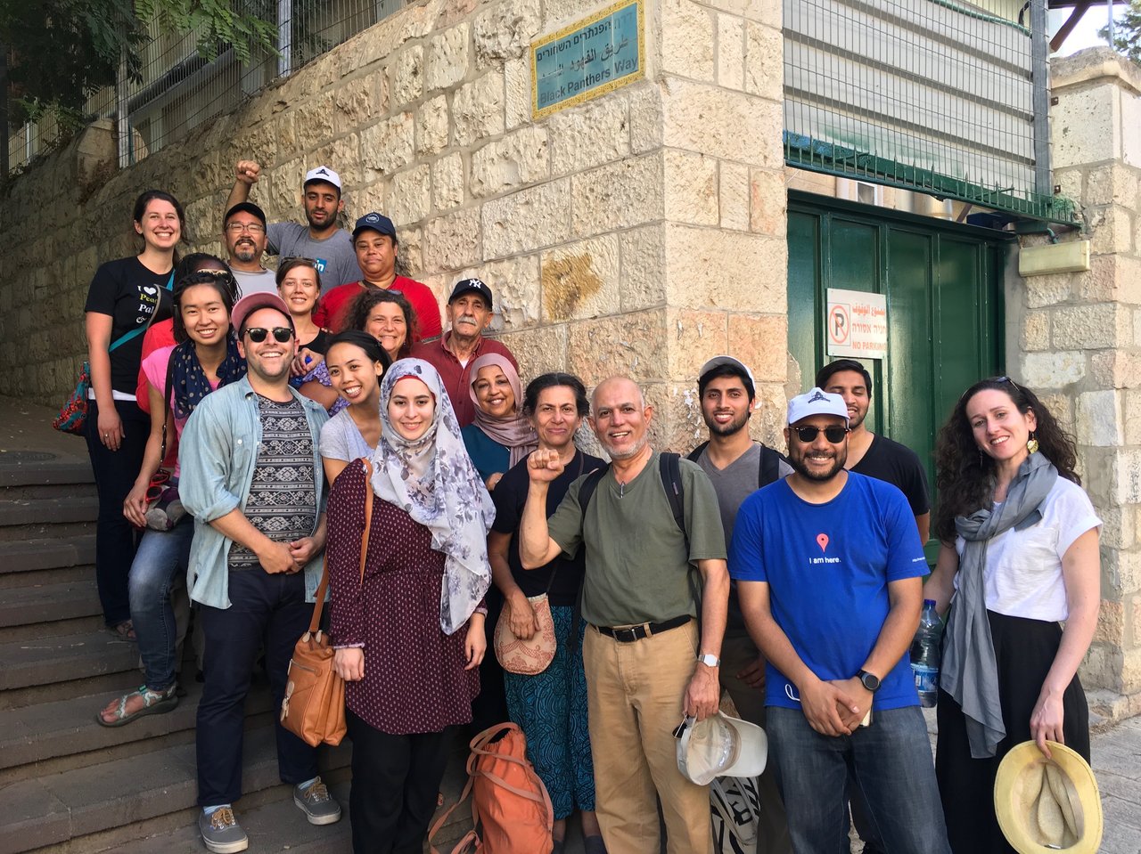 A group of Eyewitness Palestine delegates standing on a set of stairs in Jerusalem.