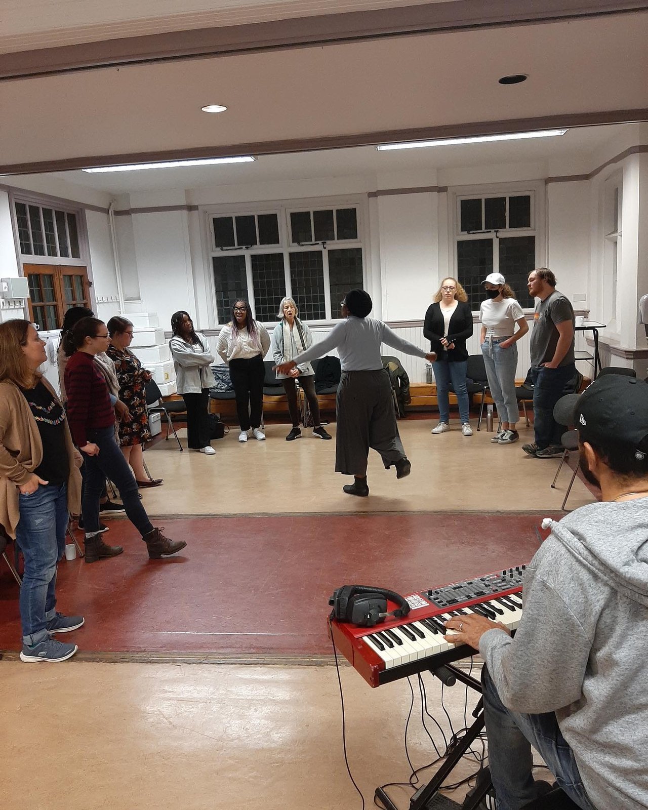 Choir rehearsing with keyboard player