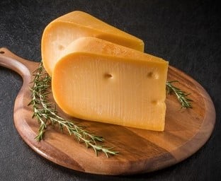 A wedge of cheese Medium Old Gouda.