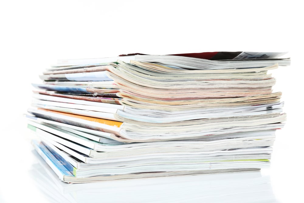 Picture of a stack of journals that functions as a link to list of published articles