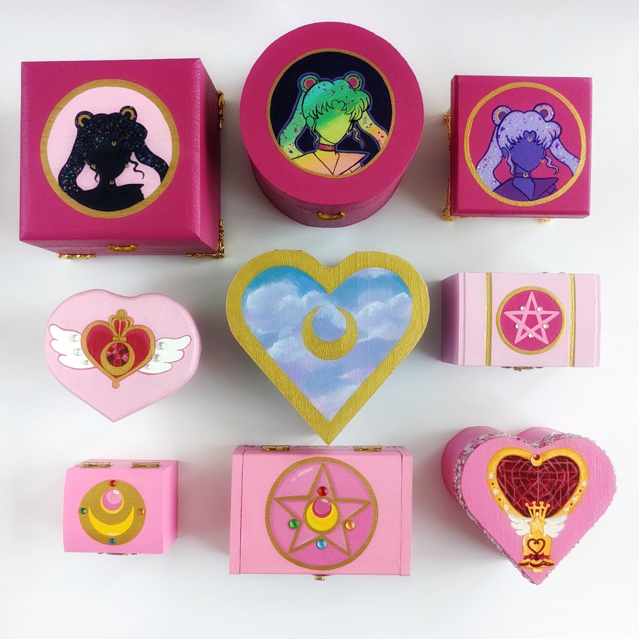Six pink boxes with Sailor Moon themed designs.