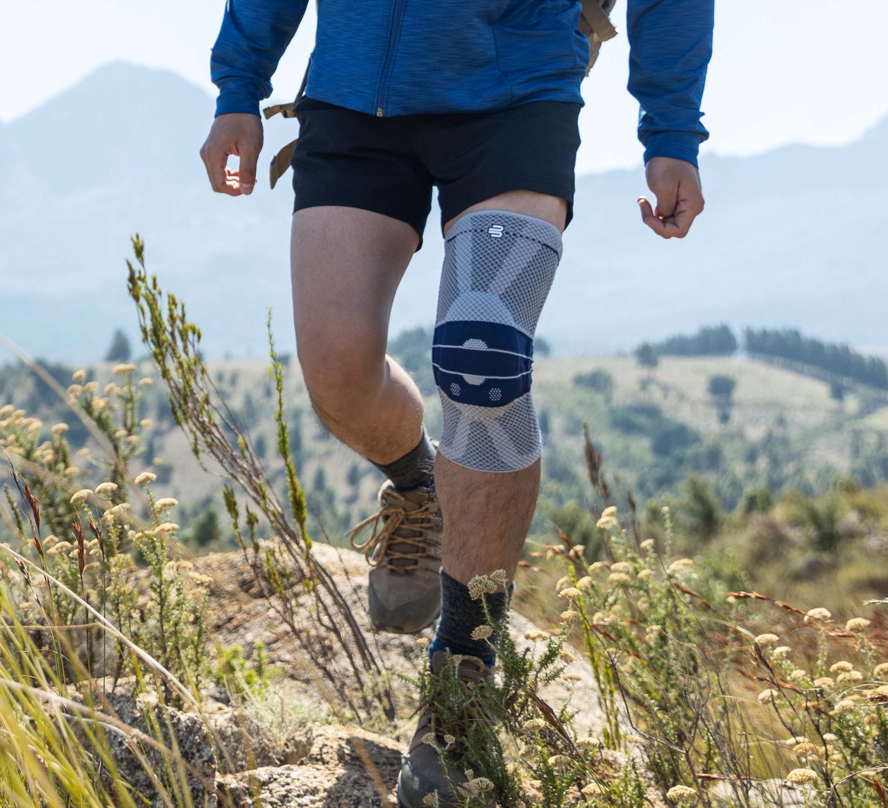 Man hiking wearing GenuTrain knee brace