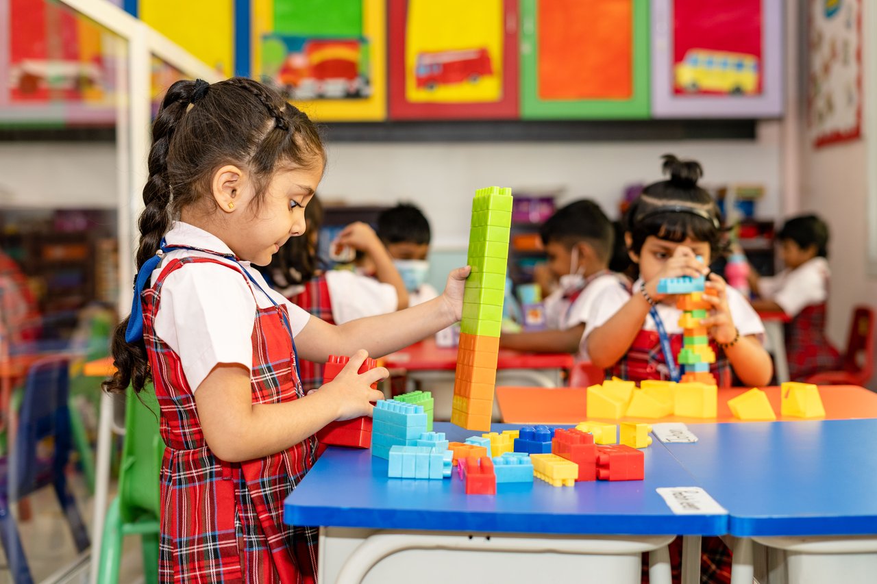 Kindergarten students playing with building blocks