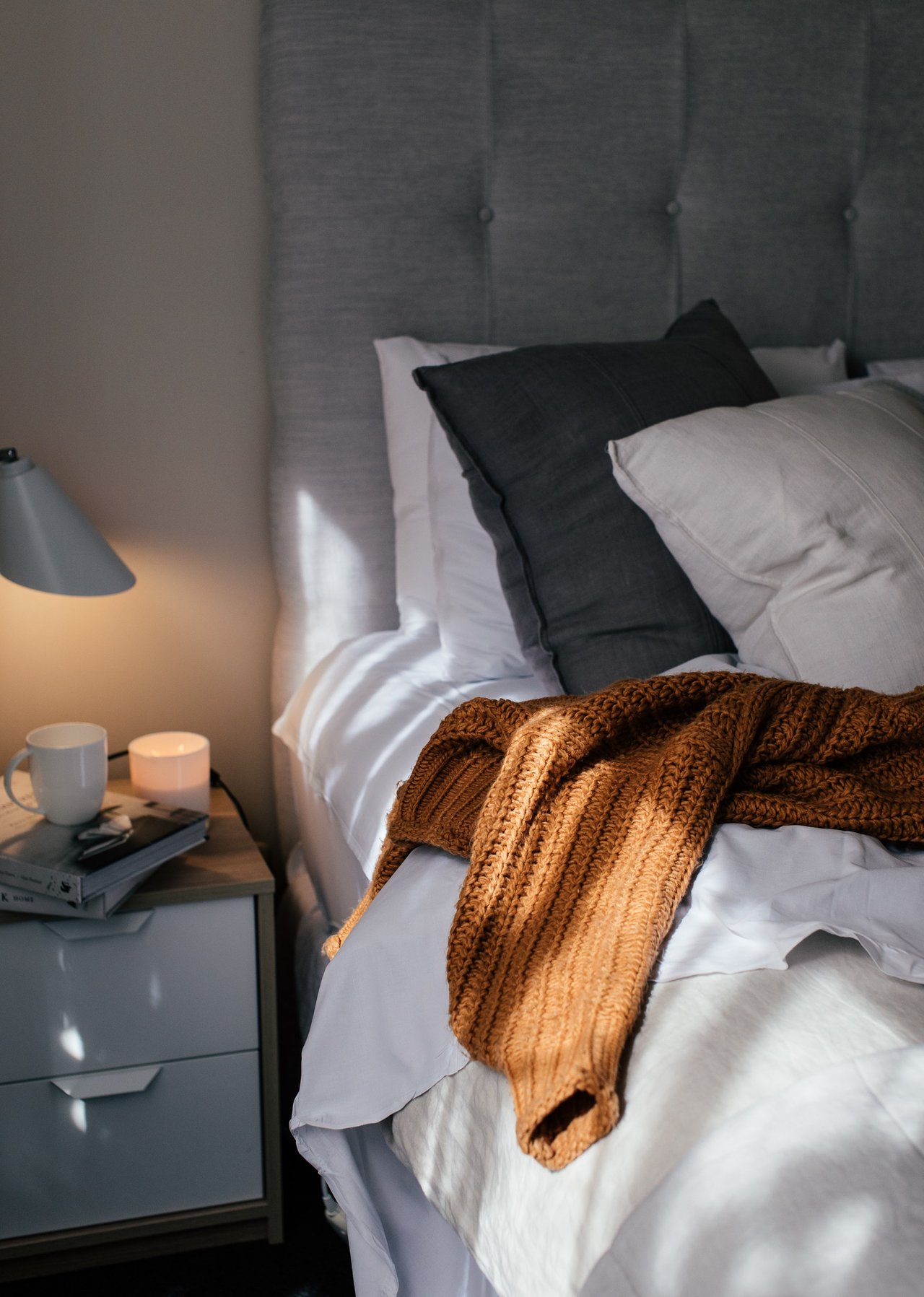A picture of a grey gold comfy bed in a rejens suite.