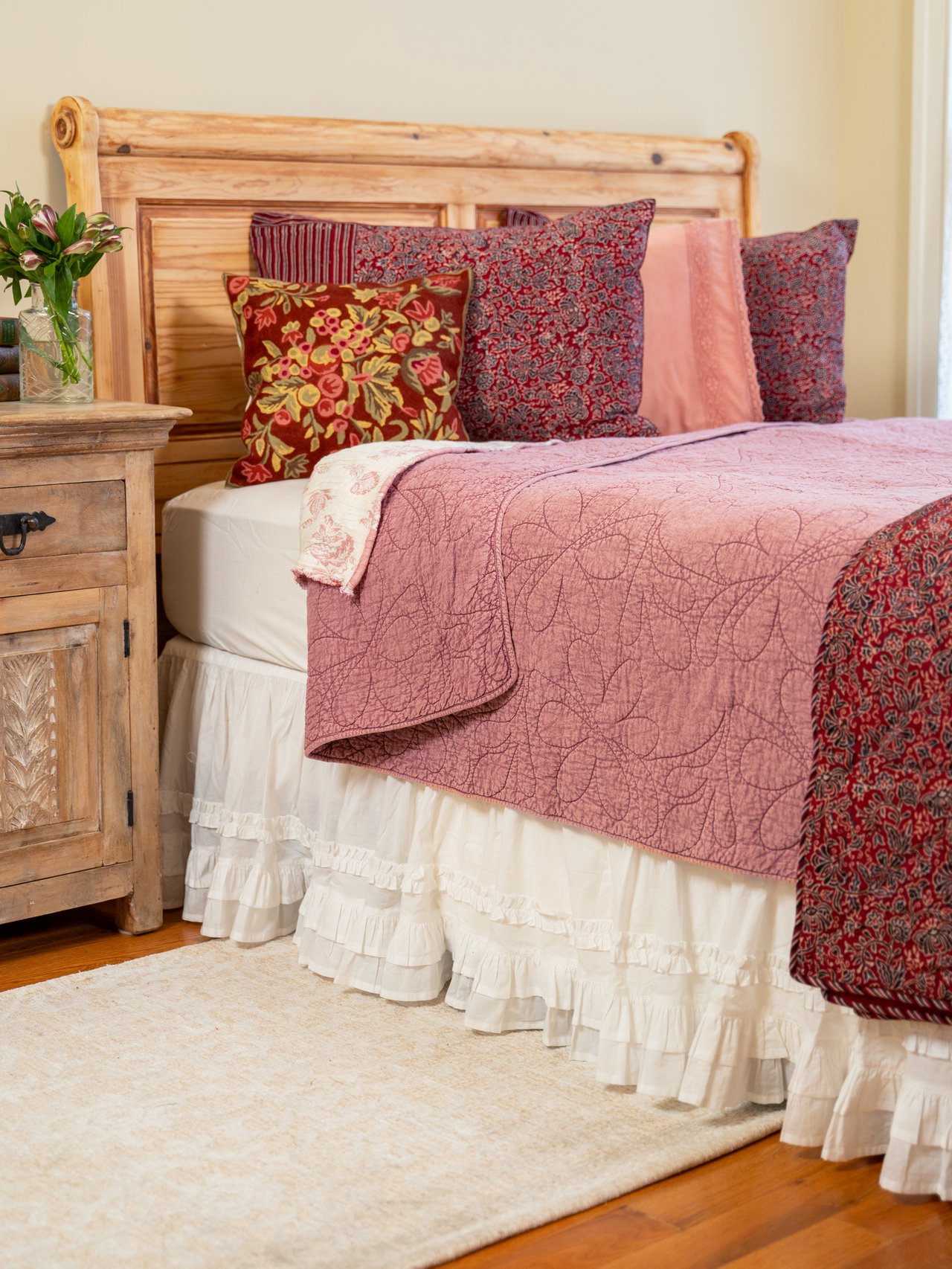 A closeup of a layered bedspread with lots of patterns and texture