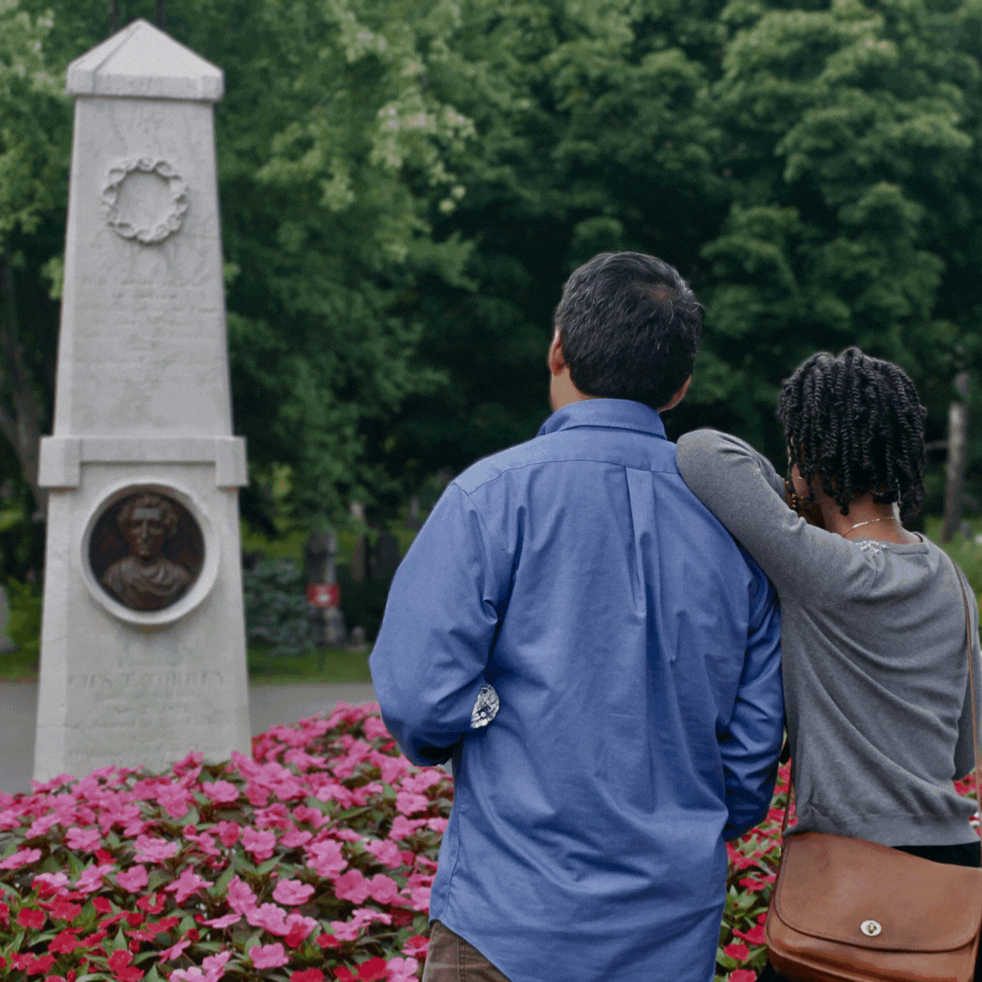 a gif of a man and a woman looking at a monument