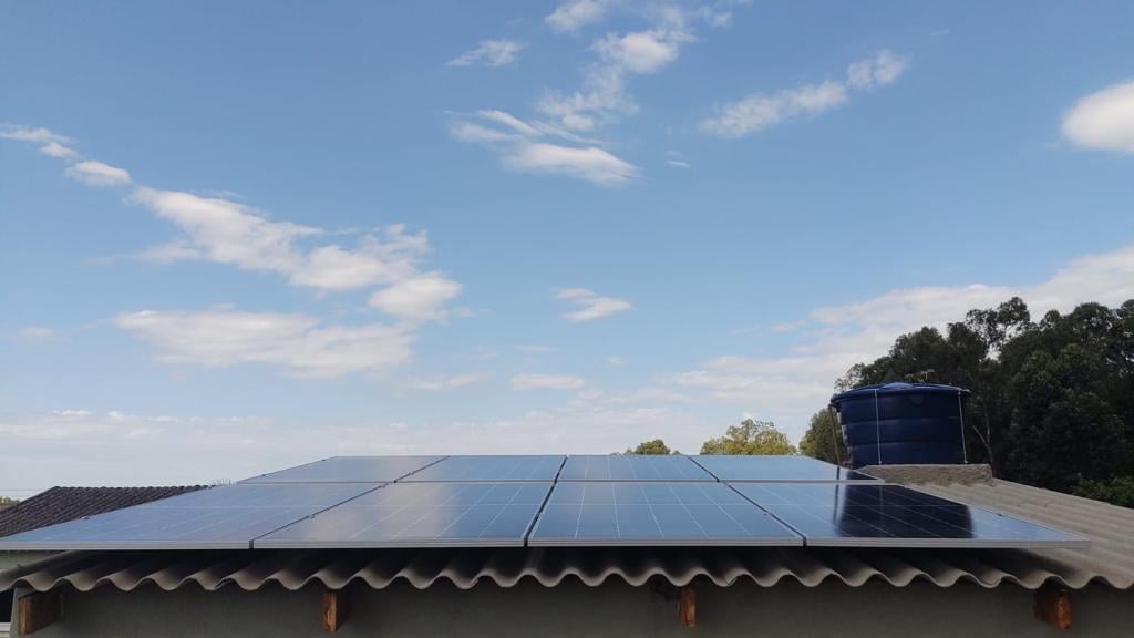 A pug dog wearing a yellow hat.