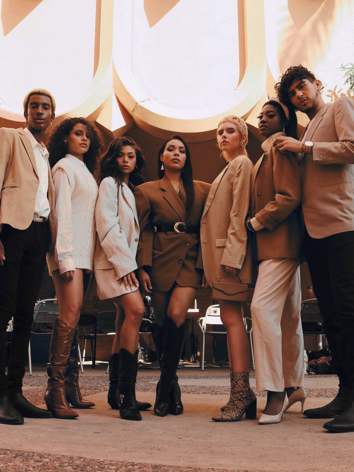  A group of diverse brown people, wearing sustainable fashion, a high fashion group pose. Commercial Fashion Photography. Fashion editorial campaign at ASU Gammage. 