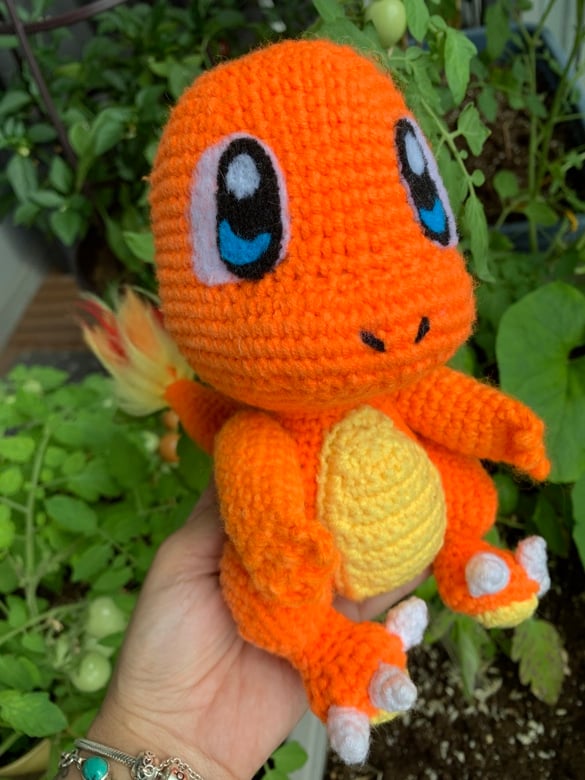 A crocheted Charmander amigurumi/doll with felt eyes