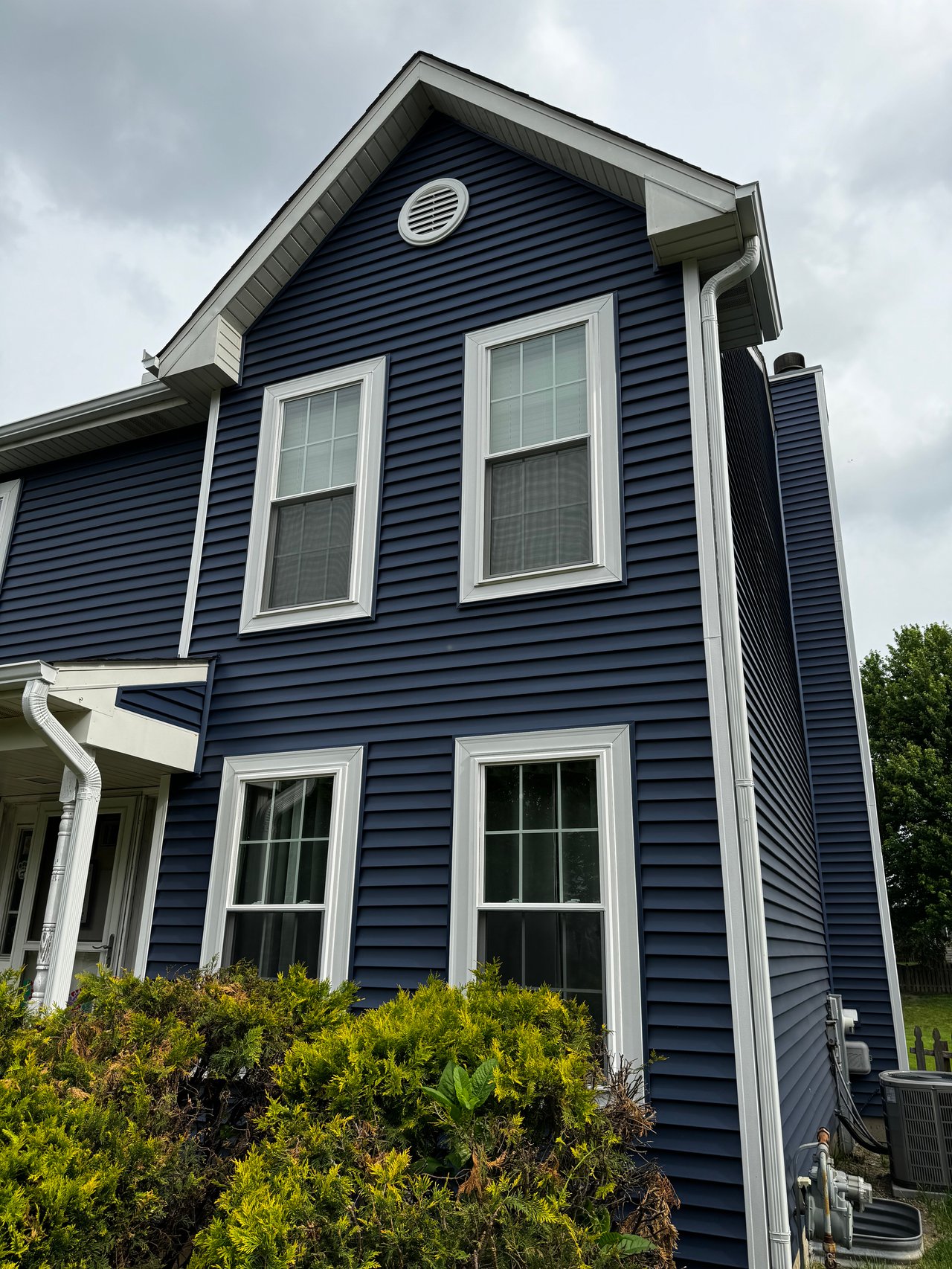 A photo of a house showcasing blue colored siding