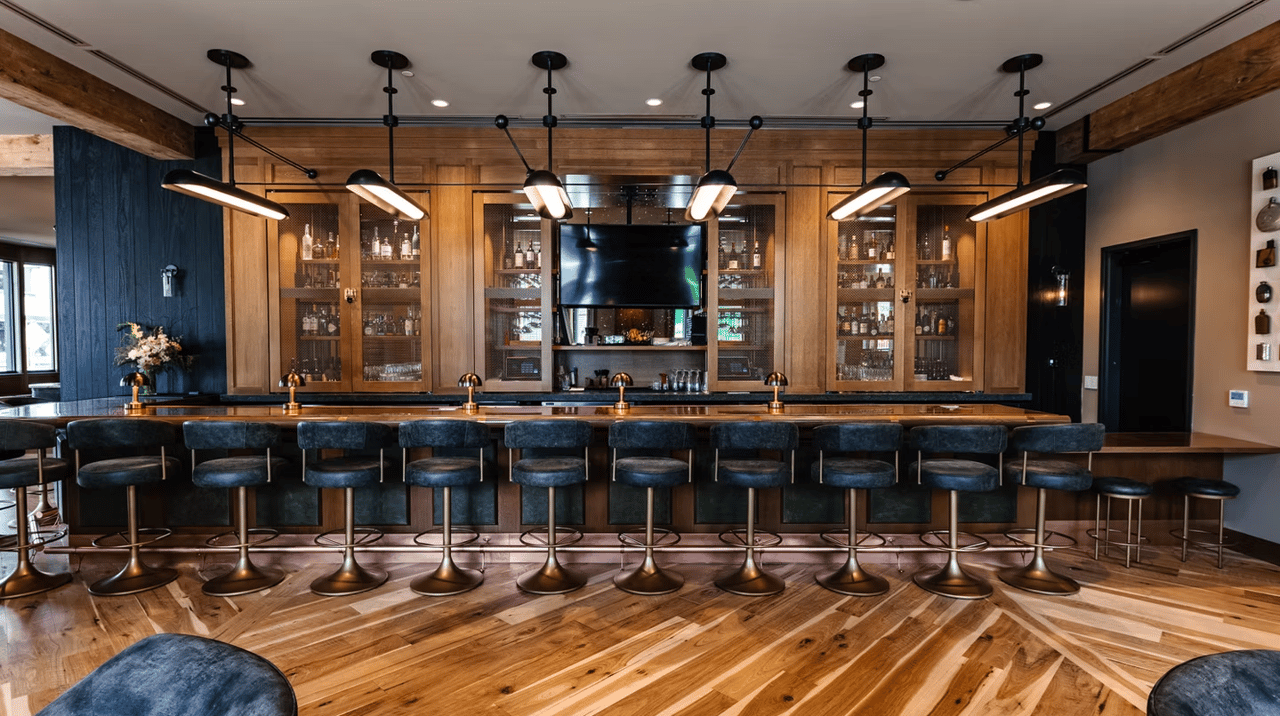 a person's cut off arm and hand holding an orange and black vinyl with the album cover showing on the left