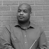 Headshot of C. L. Thomas holding a conductor's baton