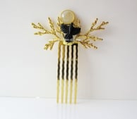 Front shot of one of my branch hair combs. This features a carved crow caught in flight from black horn and is accented with moonstone gemstone