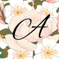 The letter A, capitilzed, in script, against a background of pale pink flowers with olive-green leaves.