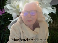 An woman with curled light hair of a certain age with glasses and cowell neck off white shirt in fromt of a large Peony image