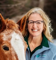 Pam Allen-LeBlanc smiling at the camera on her farm