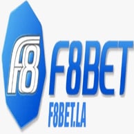 A young woman with brown hair and brown eyes in a flower shop, smiling and holding a rose close to her face