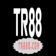 A young woman with brown hair and brown eyes in a flower shop, smiling and holding a rose close to her face