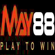 A young woman with brown hair and brown eyes in a flower shop, smiling and holding a rose close to her face