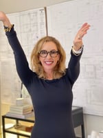 Lisa Holt with arms in the air smiling and very happy