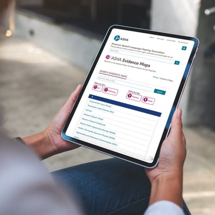 Person holding a tablet displaying the ASHA Evidence Maps website and searchable evidence resources.