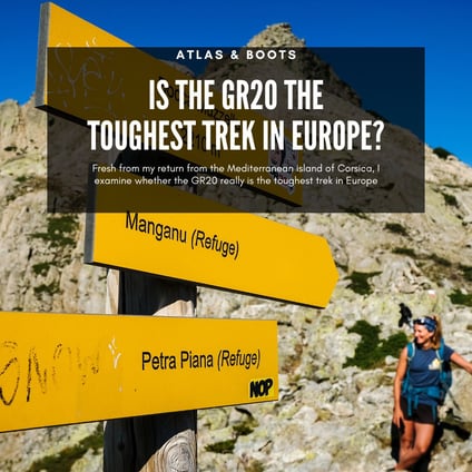 yellow trail sign on the GR20 with an exhausted hiker